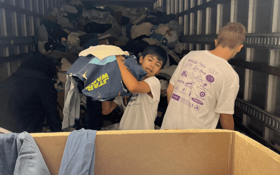 Helping unload clothes for the community